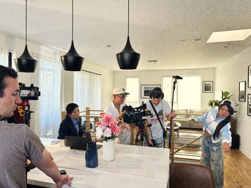The crew filming the scene at the kitchen island
