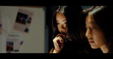 Frame from Heirloom: two women lit by a laptop screen