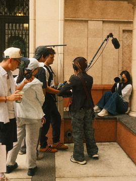 Crew gathered on a terrace with the boom overhead