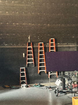 Ladders and a flag against the stage wall