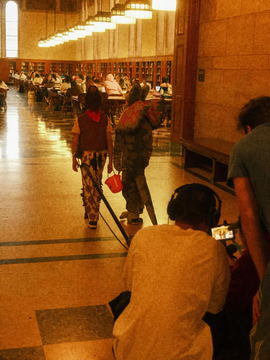 The library reading room with crew working at the near desk